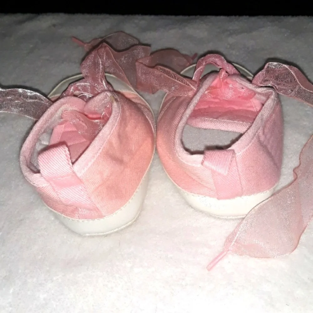 Pink baby sneakers with moon and star beaded accents and fun laces